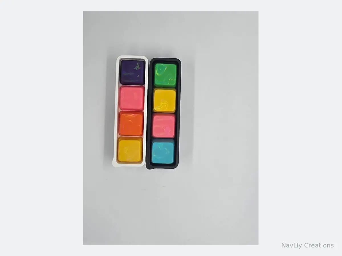 Pair of long keyboard fidgets with white and black bases and rainbow keycaps