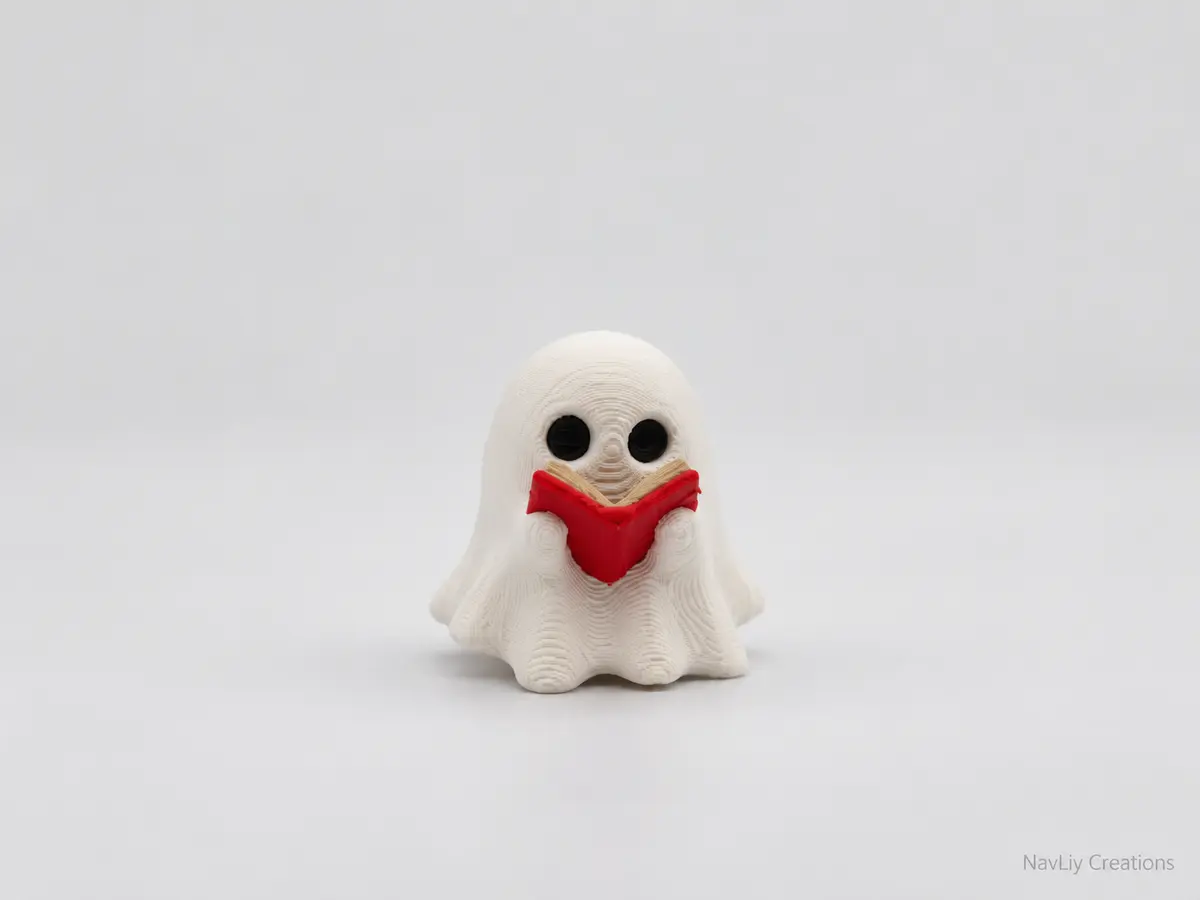 White 3D-printed ghost holding a small red book